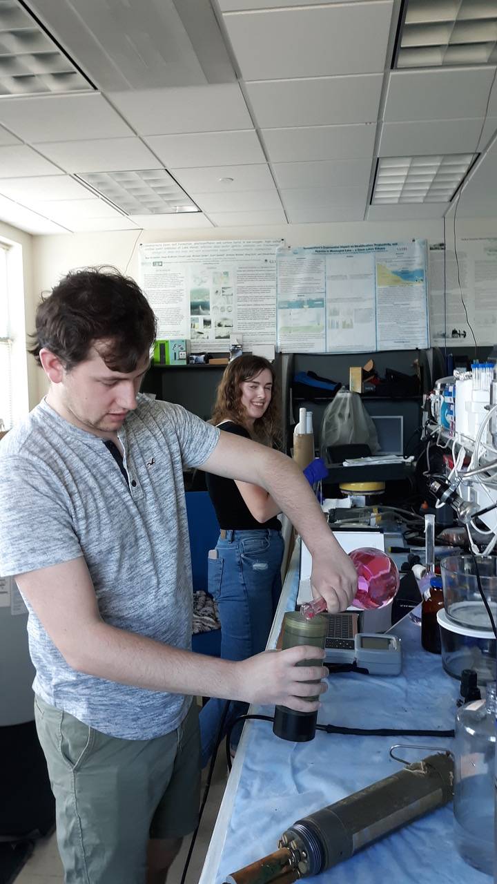 Nate pours calibrations solution and Jillian records calibration values
